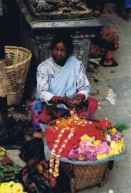 Lady making flower necklaces...