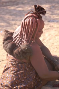 streams of braided hair, coloured and put in shape with otjize paste.