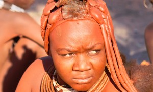 Himba woman in the distinct ocre colours ...